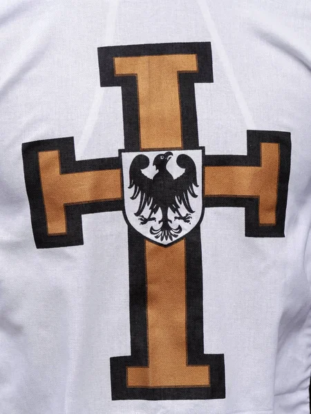 White cape with Teutonic cross