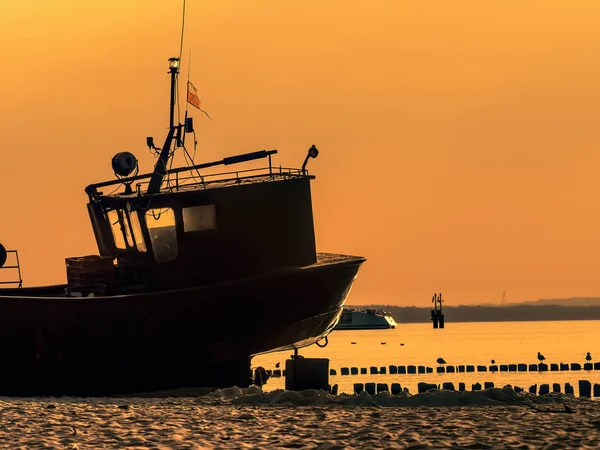 Fish cutter moored at the sandy beach