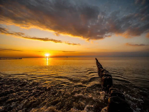 Surfer surfing against the sunset