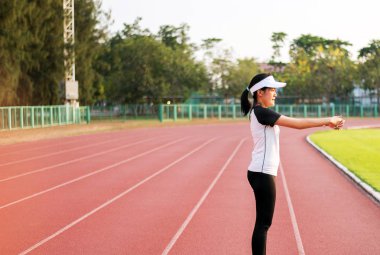 Asya güzel kadın statik germe ve çalışan ya da kamu parkta çalışmadan önce ısınma