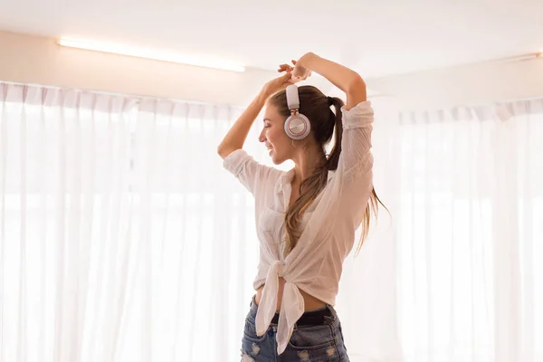 Young Beautiful Woman Using Headphone Listening Music Dance Bedroom Relaxing — стоковое фото