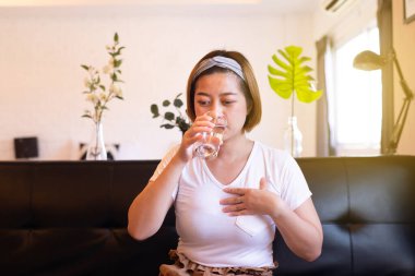 Asyalı kadın reflü, gastroözofageal reflü, su içen.