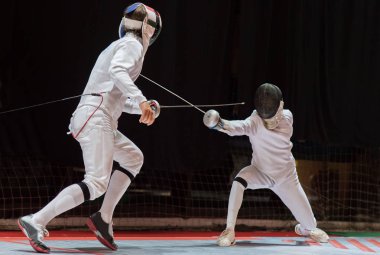 Two man fencing athletes fight on professional sports arena  clipart