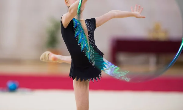 Girl in beautiful gymnastic dress doing exercise