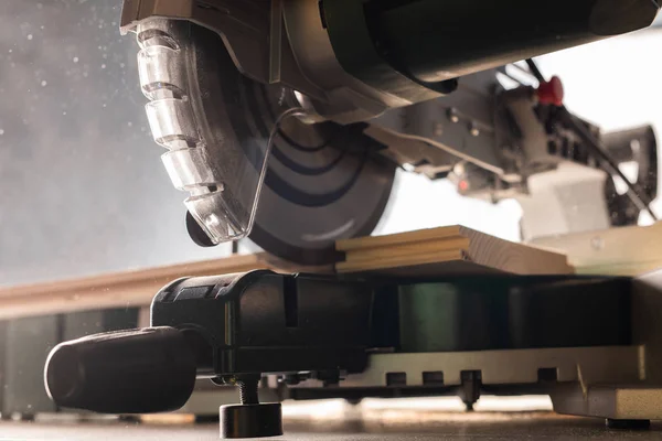 Modern electric circular saw in the workshop — Stock Photo, Image