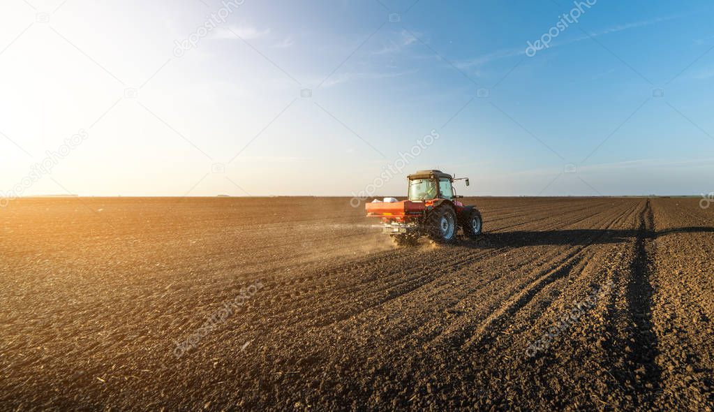 Farmer fertilizing arable land 