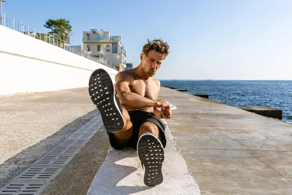 Handsome Adult Shirtless Sportsman Doing Side Crunches Seashore — Stock Photo, Image