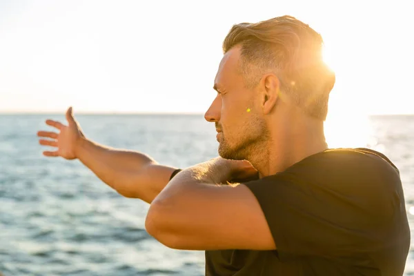 Handsome Adult Sportsman Stretching Arm Training Seashore Front Sunrise — Stock Photo, Image