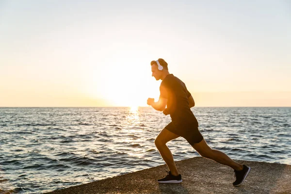 Sporty Adult Man Headphones Doing One Legged Squats Training Seashore — Stock Photo, Image