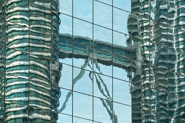 Malaysia. Mirror reflection of the many skyscrapers of the capital of Kuala Lumpur, built of glass and concrete.