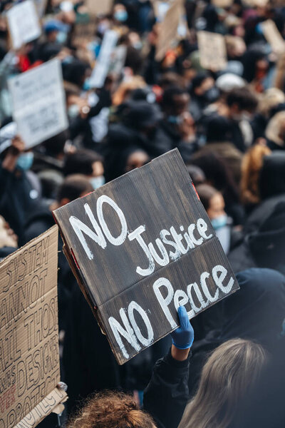 London / UK - 06/06/2020: Black Lives Matter protest during lockdown coronavirus pandemic. No justice no peace sign