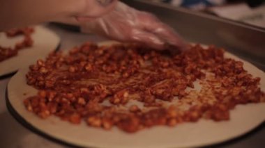 Şef douth 'un üstüne barbekü soslu tavuk ekleyerek bbq tavuklu pizza yapıyor..