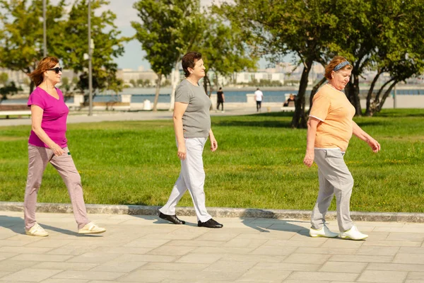 Trois femmes qui courent dans un parc public, ayant un mode de vie sain pour l'immunité. — Photo