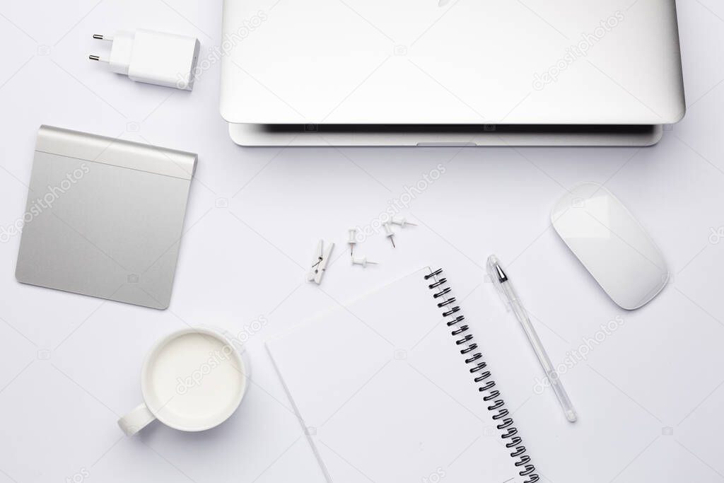 Empty white notebook with pen, working place with keyboard.