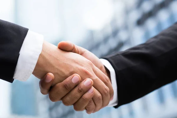 Close Up of a businessman hand shake between two colleagues.or Negotiated agreement successful job.