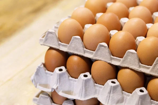 raw chicken eggs in egg box on the table wooden.