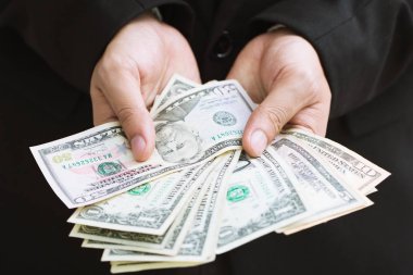 Resmi takım elbise yakın yukarı el iş adam para veren para yayılmasını tutar.