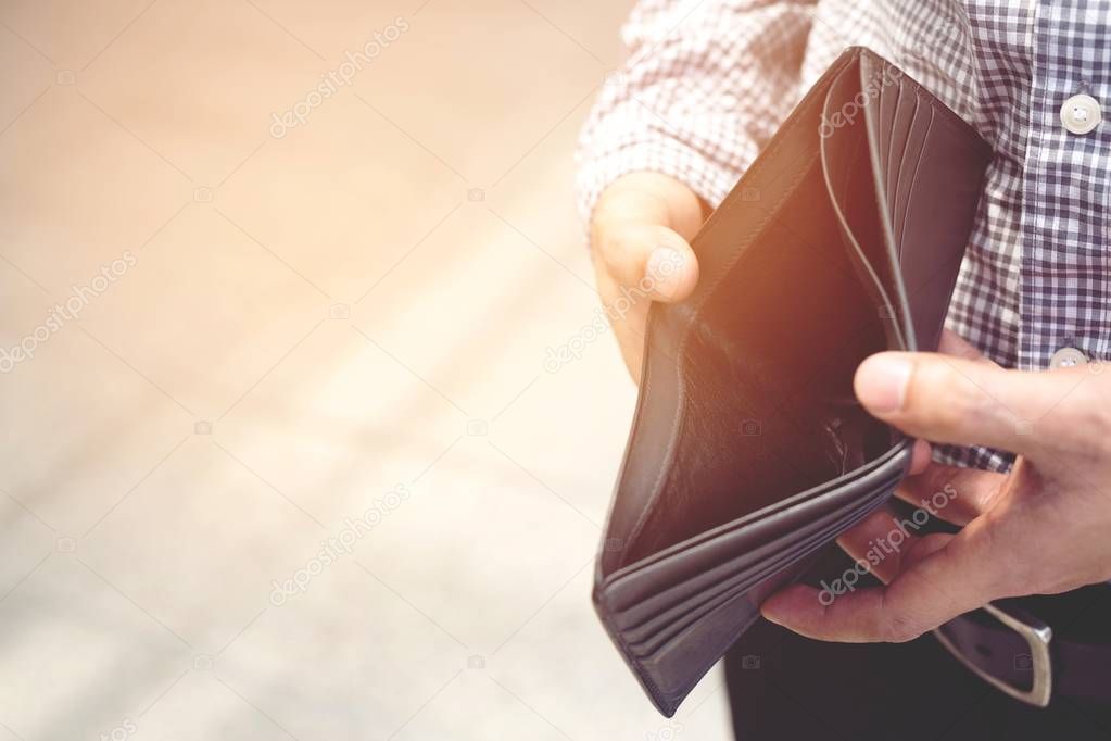 Empty wallet (no money) in the hands of an man. Cost control expenses poverty in concept