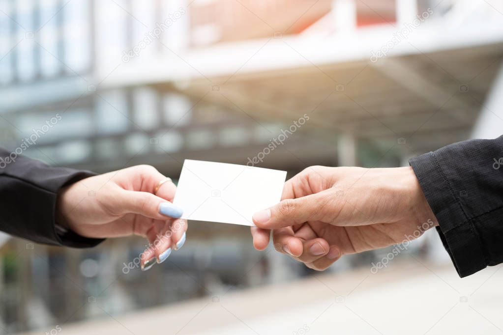 business man in hand hold show business cards blank empty white card mock up filing give to connect Partner contacts on the desk in office. Business branding Successfully connected in business concept