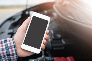 yakın bir cep telefonu akıllı telefon arama kullanarak genç iş adamı el bir araba tamircisi yardım isteyin çünkü araba yol kenarında kırık. boş ekran varsa.