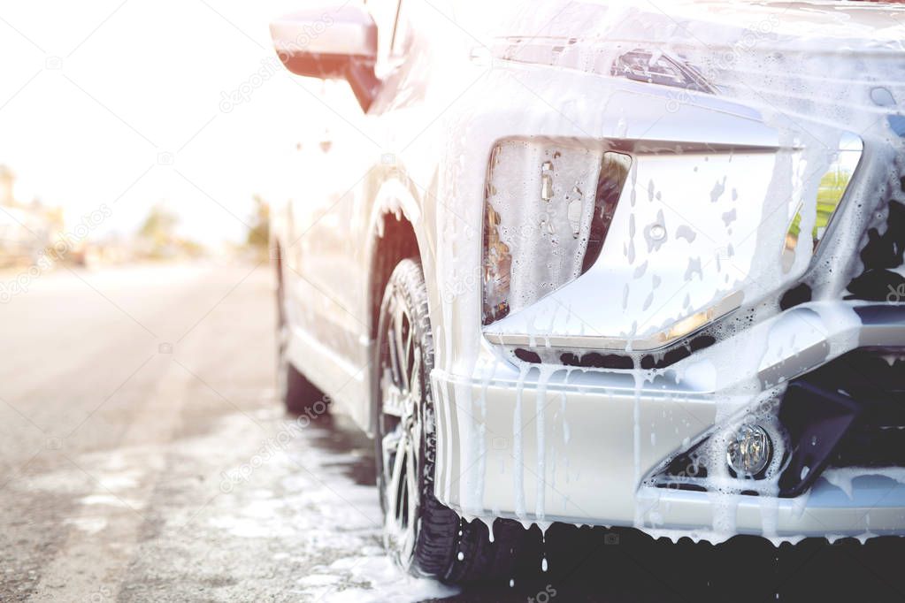 people man holding hand blue sponge for washing car. Concept car wash clean.