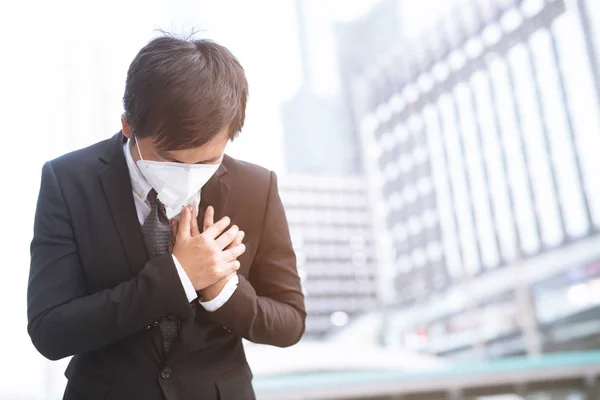 Portrait of man wearing facial hygienic mask nose outdoors. Ecology, air pollution car, Environmental and virus protection concept flu health against toxic dust covered the city of a health effect.