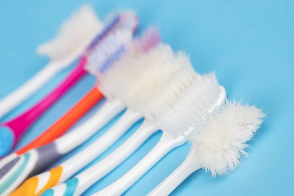 Old Toothbrush Used Expired Damaged Variety Colors Blue Background Concept — Stock Photo, Image