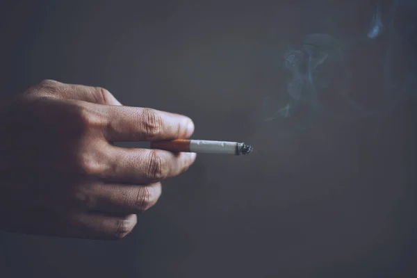 Man Holding Smoking Cigarette Hand Cigarette Smoke Spread Dark Background — Stock Photo, Image