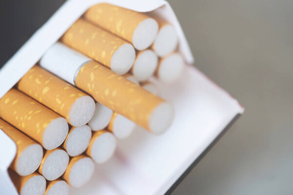 peel it off Cigarette pack prepare smoking a cigarette. Packing line up. photo filters Natural light. soft focus.