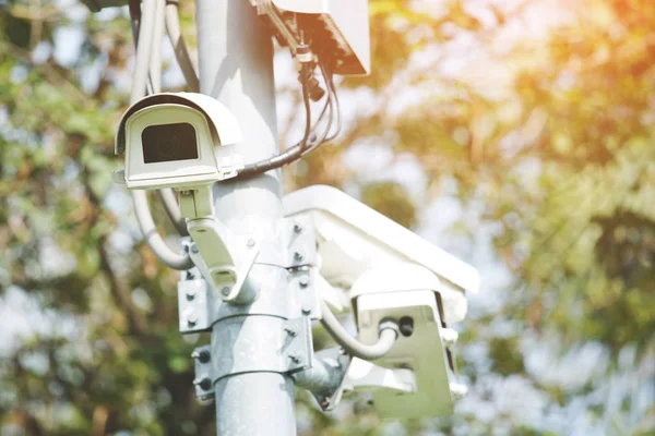 Multi-angle CCTV cameras are installed in the green park public, concept CCTV camera operating watching city security cover of theft. soft focus.