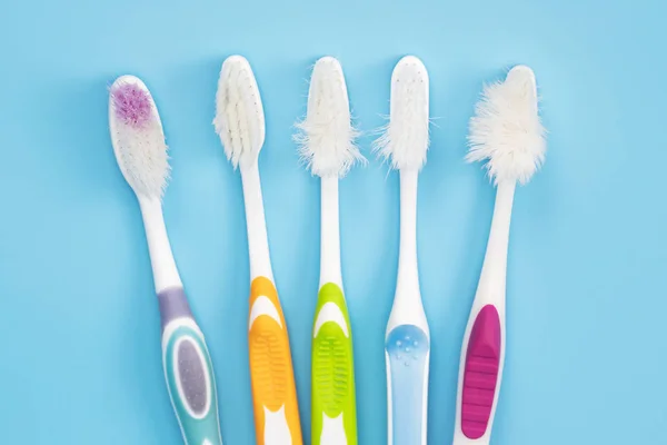 Old Toothbrush Used Expired Damaged Variety Colors Blue Background Concept — Stock Photo, Image