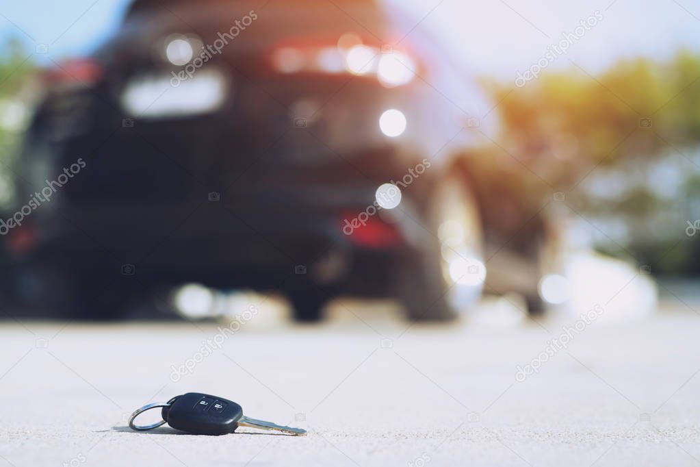 abstract lost car keys fall lying on the street concrete cement ground roadway home front yard.
