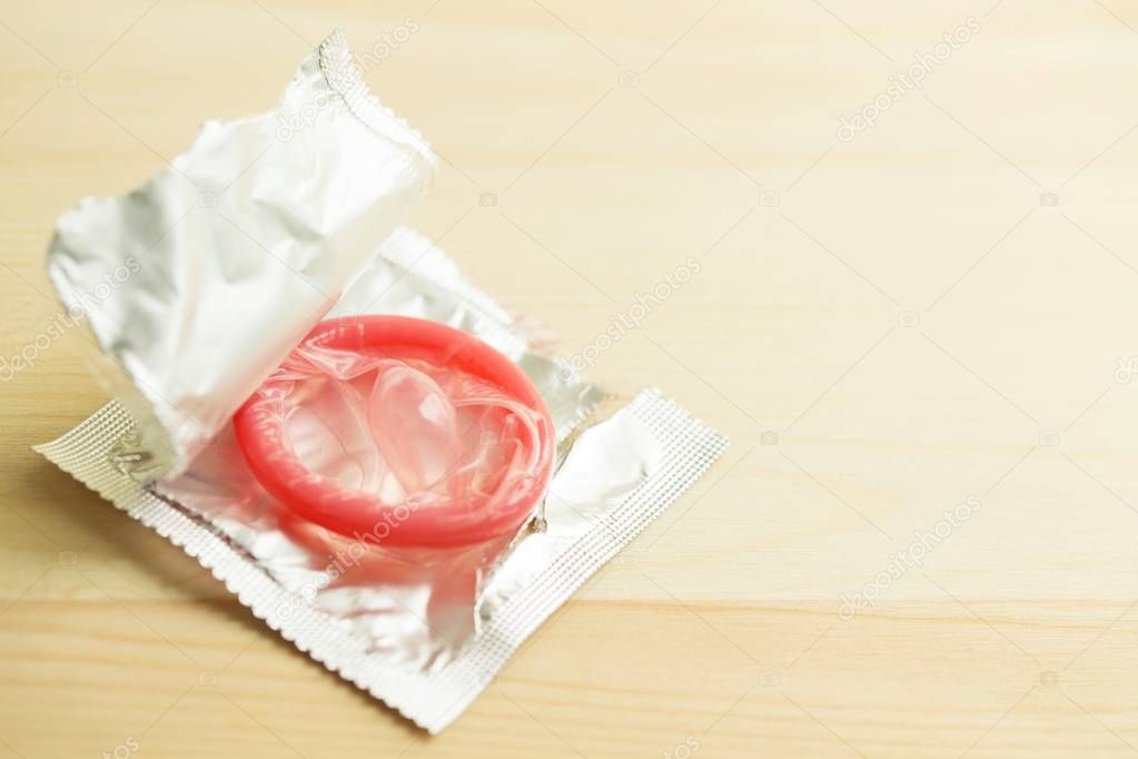 Close up shot of condoms pack on table wooden background. concept Contraception Contraceptives control the birth rate or safe prophylactic. Leave copy space empty to write text on the side.