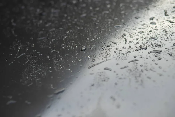 Rain drops and dew. water drops on a gray car roof after stopped raining , selective focus waterproof surface. soft focus. Leave space for writing text background.