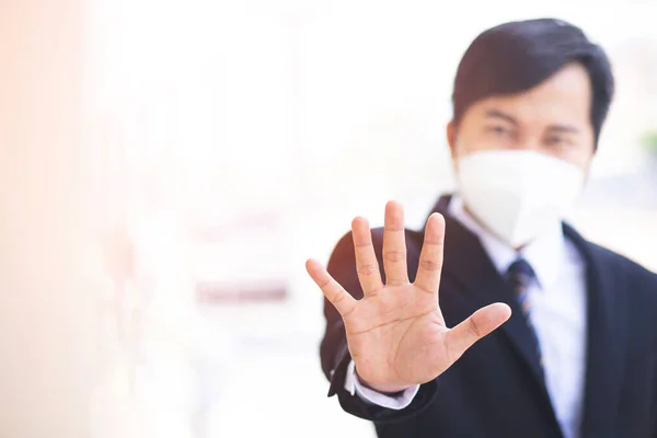 A business man wears a mask to protect Corona virus before going to work at the office.