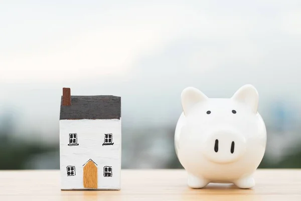 Savings home and piggy bank