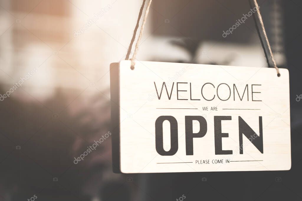 business sign that says Open on cafe or restaurant hang on door