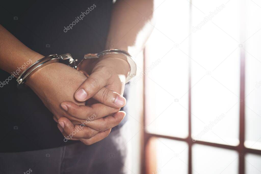 Hand of the prisoner on a steel lattice 