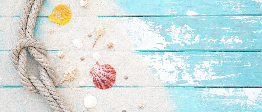 Summer time concept with sea shells and starfish on a blue wooden background