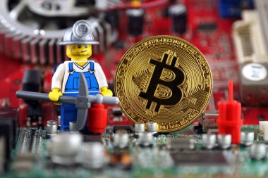 Wroclaw, Polonya - 01 Eylül 2018: Bitcoin, madenci (olarak Lego rakam) ve arka plan üzerinde tümleşik devre fiziksel sürümü. Yüksek teknoloji kavramı.