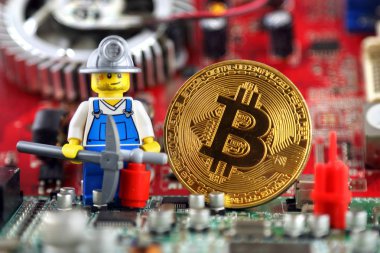 Wroclaw, Polonya - 01 Eylül 2018: Bitcoin, madenci (olarak Lego rakam) ve arka plan üzerinde tümleşik devre fiziksel sürümü. Yüksek teknoloji kavramı.