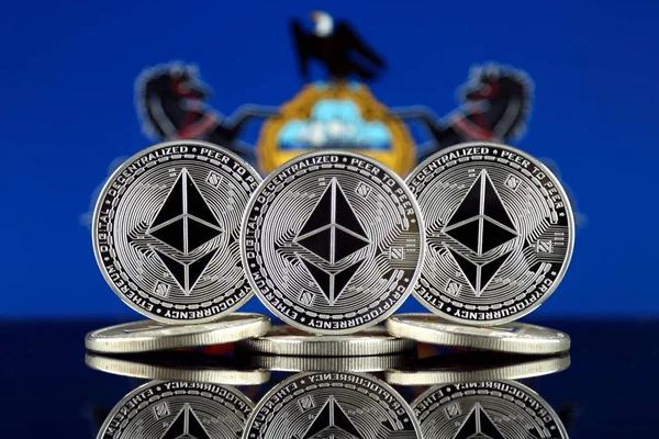Physical version of Ethereum (ETH) and Pennsylvania State Flag. Conceptual image for investors in cryptocurrency, Blockchain Technology, Smart Contracts, Personal Tokens and Initial Coin Offering.