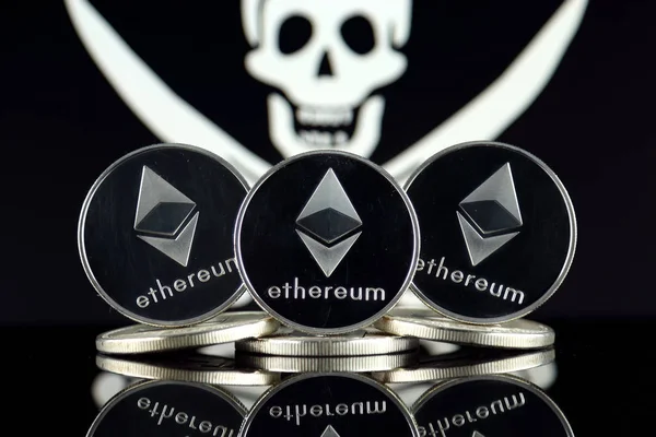 Physical version of Ethereum (ETH) and Pirate Flag. Conceptual image for investors in cryptocurrency, Blockchain Technology, Smart Contracts, Personal Tokens and ICO. Risk, safety and security.