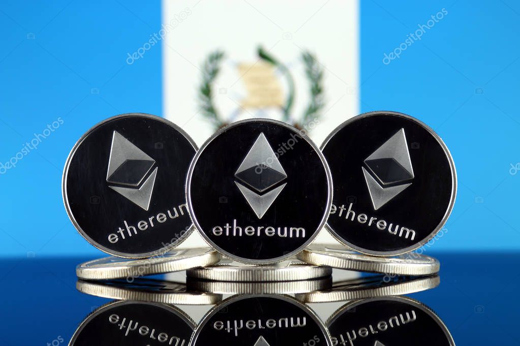 Physical version of Ethereum (ETH) and Guatemala Flag. Conceptual image for investors in cryptocurrency, Blockchain Technology, Smart Contracts, Personal Tokens and Initial Coin Offering.