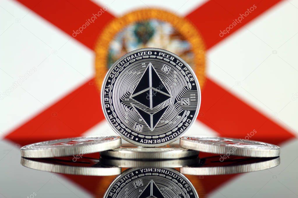 Physical version of Ethereum (ETH) and Florida State Flag. Conceptual image for investors in cryptocurrency, Blockchain Technology, Smart Contracts, Personal Tokens and Initial Coin Offering.