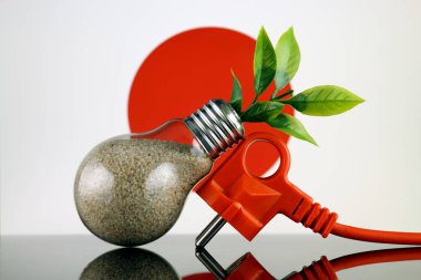 Tak, ampul ve Japonya bayrağı içinde büyüyen bitki. Yeşil eko yenilenebilir enerji kavramı.