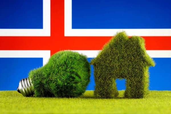 Green eco light bulb, eco house icon and Iceland Flag. Renewable energy. Electricity prices, energy saving in the household.