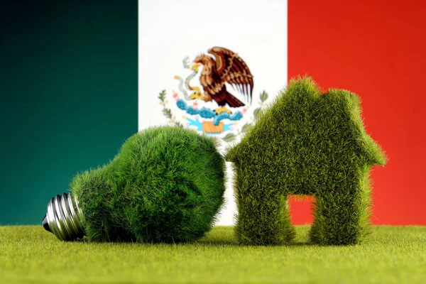 Green eco light bulb, eco house icon and Mexico Flag. Renewable energy. Electricity prices, energy saving in the household.