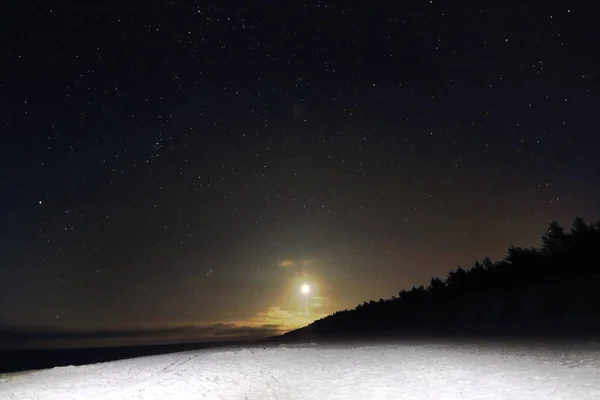 Slowinski National Park on the Baltic Sea coast, near Leba, Poland. Night view, starry sky right after the moon rising. Beautiful sandy beaches and coastal landscape.