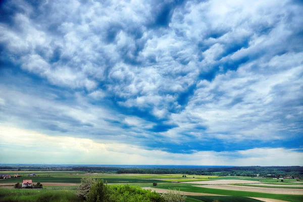 WROCLAW, POLAND - MAY 28, 2020: Beautiful, green fields and cloudy sky in the end of may. View from the Trzebnica hills, near Wroclaw, Poland, Europe.